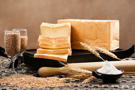 Bread loaf arranged with grain and wheat
