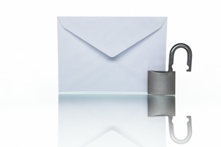 PHOTOGRAPH (NOT illustration or 3D render) of envelope mail and unlocked lock to symbolize Unprotected mail, shot against white backgroundの写真素材