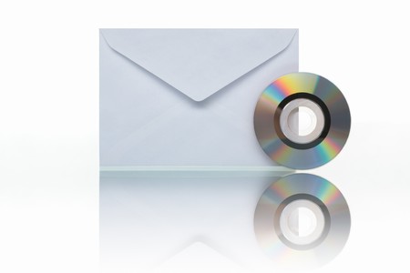 PHOTOGRAPH (NOT illustration or 3D render) of envelope mail and small CD to symbolize mail backup/archive, shot against white backgroundの写真素材