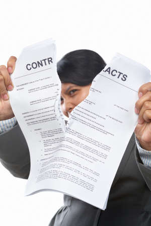 Asian businesswoman tearing up the contract papersの写真素材