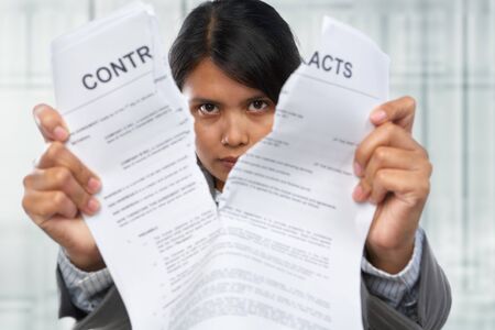Asian businesswoman tearing up the contract papersの写真素材
