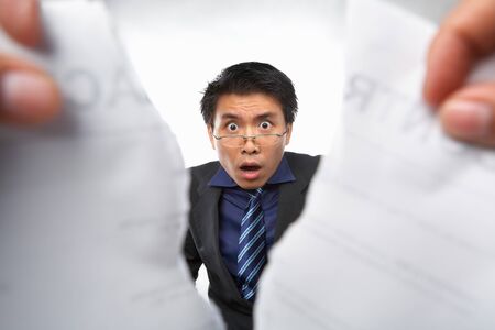 Contract refusal or rejection with shocked Chinese businesman as main focusの写真素材