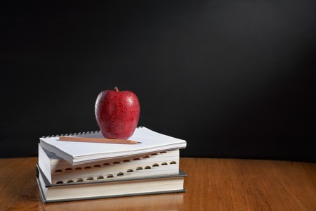 Red apple over pile of books for shool conceptの写真素材