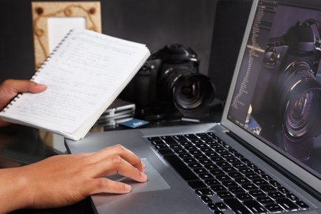 Photographer still working on the photos using laptop