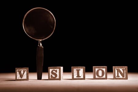 Vision concept, consisting letter blocks and magnifying glassの写真素材