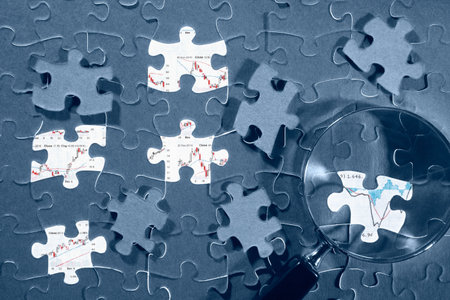 Jigzaw puzzle and economic graph under it, showed on mssing pieceの写真素材