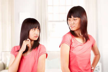 Two Chinese girls having sibling fight between themの写真素材