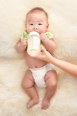 Chinese baby boy feeding milk from baby's bottleの写真素材