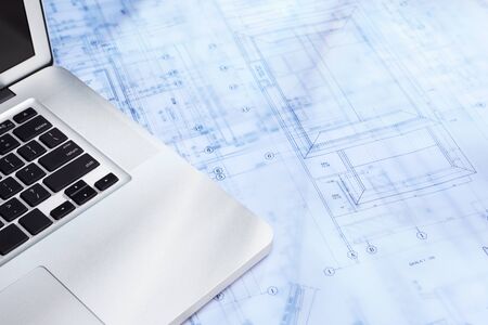 Laptop over blueprint of a residential structure designの写真素材