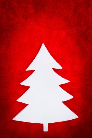 Chrsitmas tree shape made from white styrofoam on red fabricの写真素材
