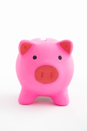 Pink piggy bank over white backgroundの写真素材