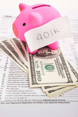 Pink piggy banks over the tax formの写真素材