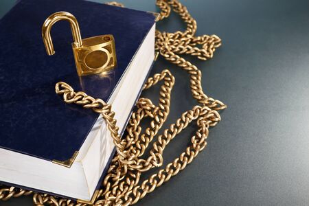 A hard cover book with golden chain and lockの写真素材