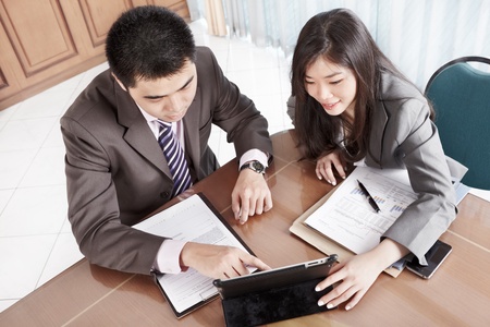 Two business people working together in the officeの写真素材