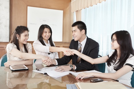 Group of business people handshaking to each other in the oficeの写真素材