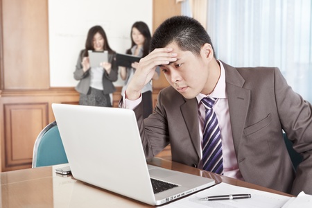 Asian businessman looks so depressed in the officeの写真素材