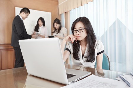 Businesswoman working with laptop in the officeの写真素材