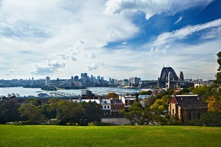 North Sydney on far aside connected with Sydney harbour bridgeの写真素材