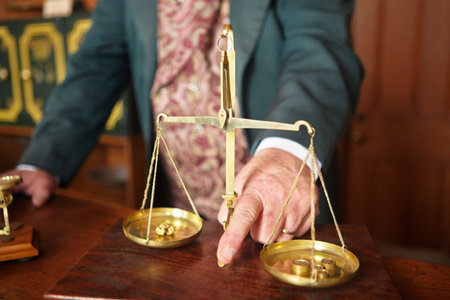 Ad old man hand holding the scale to weigh the gold rockの写真素材