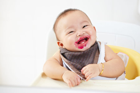 Baby girl after being eating loking at camera smiling