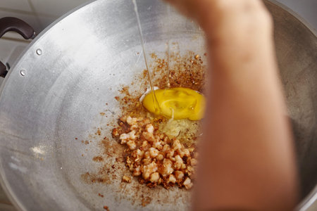 Egg added to the cooking wokの写真素材