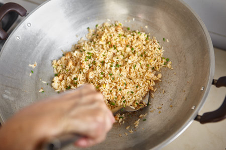 Stiring the fried rice with spatula, some slight movement blur might be noticableの写真素材