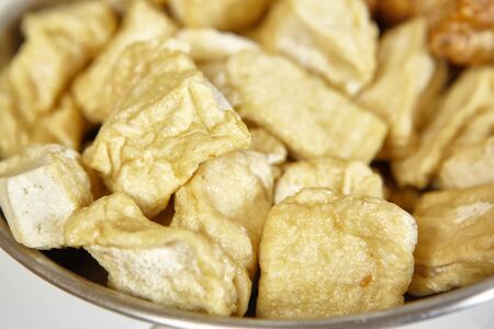 Fried tofu on a plate as ingredient for cookingの写真素材