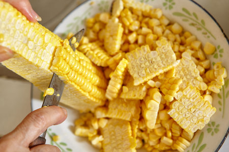 Preparing ingredient by cutting corn to make deep fried ote-ote, traditional indonesia snack