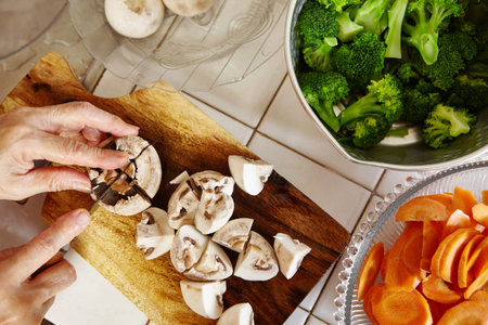 Hand cutting vegetable for use in cookingの写真素材