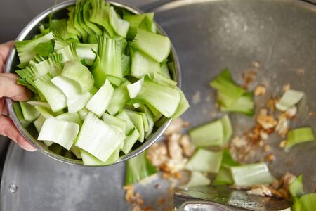 Stir frying Chinese cabbage on the wokの写真素材