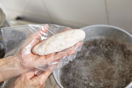 Progress fish cake being boiled in hot waterの写真素材