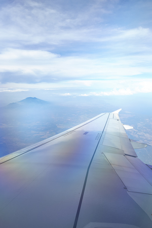Windows view of flight on wing side of the planeの写真素材