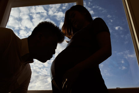 Young couple silhouette showing pregnancy