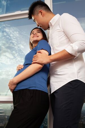 Young Asian couple showing affectionate waiting for the baby bornの写真素材