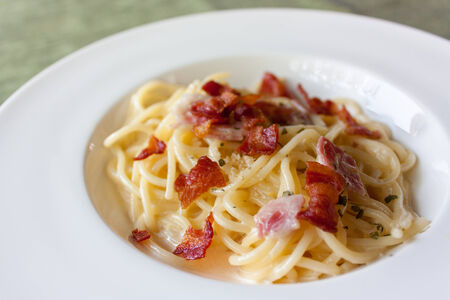 Spaghetti Carbonara with bacon and cheese on deskの写真素材