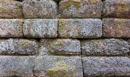 Old stone wall texture with mossの写真素材