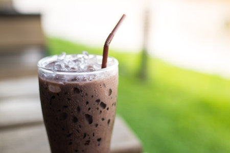 iced morning chocolate on wooden table , close upの写真素材