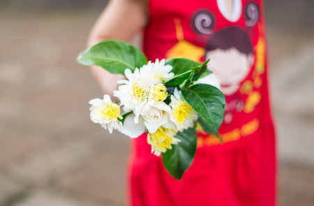 flower in hands of a child ,little girlの写真素材