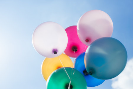 multicolored balloons on blue sky backgroundの写真素材