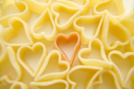Heart shaped tricolor pasta on white  backgroundの写真素材