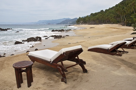 Lounge chairs on a remote Pacific Ocean beach, south of Puerta Vallarta, Mexicoの写真素材