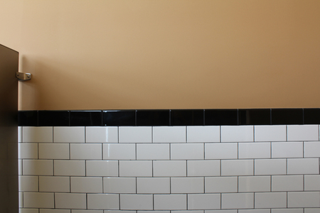 Tiled wall of a public toilet stallの写真素材