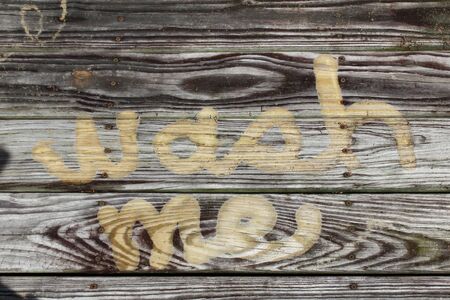 Wash me concept pressure washed into weathered woodの写真素材