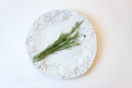 White plate with Pipicha, chepiche, Porophyllum linaria Mexican herb food ingredient, isolated on white, horizontal aspectの写真素材