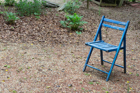 Empty blue folding chair outdoors, copy space, death grief absense concept, horizontal aspectの写真素材