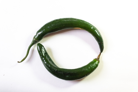 Circle background formed by two chilaca peppers, creative copy space, horizontal aspectの写真素材