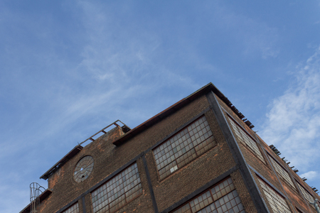 View up a corner of a derelict industrial factory building, rust belt, horizontal aspectの写真素材
