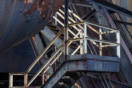 Bolted metal industrial stairway, peeled paint and rusted metal, horizontal aspectの写真素材