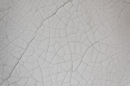 Close detail of heavy white paint over plaster with cracking, horizontal aspectの写真素材