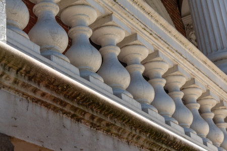 Chunky balusters on an exterior porch with stains and mold underneath, architectural detail,...